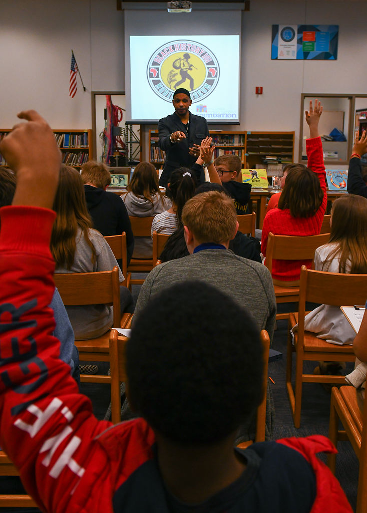 Khalid el-Hakim, curator and founder of the Black History 101 Mobile Museum, asks students to share what they collect